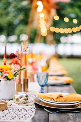 Wedding boho arch decorated with flowers for ceremony against the forrest landscape. wedding ceremony in boho style. Outdoor party
