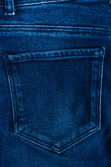 Blue jeans texture with a pocket. Vertical orientation.