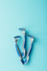 Blue shaving machines in a row on a blue background