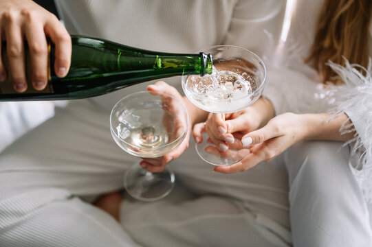 holidays and dating concept - couple drinking champagne from very stylish glasses. Celebrate life. Win win