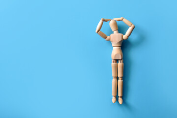 The wooden man is holding his head. A symbol of human problems and headaches