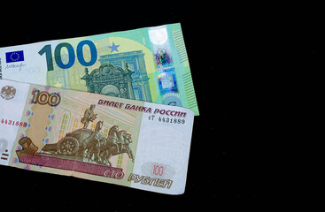 Russian rubles and euro on a black background