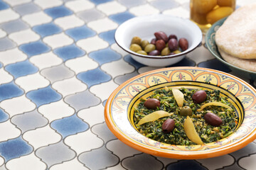Moroccan mallow salad; the leaves are chopped, steamed and then sauteed with olive oil, spices, olives, and preserved lemons.
