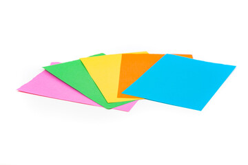 Fan of blank multicolored note pad papers isolated over white.