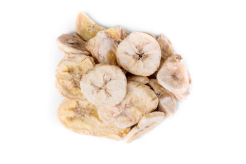 Freeze dried banana pieces in a heap isolated over white. Top down view