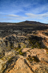 Fototapeta na wymiar View through the lava field of Leirhnjúkur volcano to the Krafla explosion crater, northern Iceland