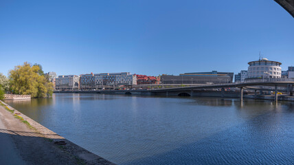 The district Norrmalm at the canal Karlbergskanalen with the transit route Klarastrandsleden and the northern railway passage to the central station a sunny day in Stockholm