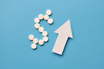 a dollar icon made of pills and an up arrow. The cost of the price of medicines is rising