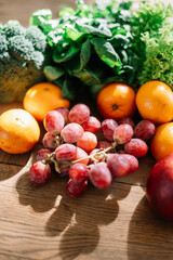 The concept of a healthy diet. Platter fruits and vagetables - orange, pear, apple, pomegranate, grapes, peach, apricot. Vegan cuisine. Flat lay. Top view.