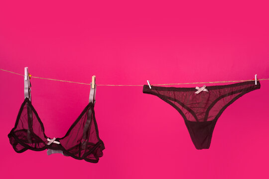 Lace panties. The sexy lingerie isolated on the pink red background. Thong bikini panties, black bra and underwear lingerie.