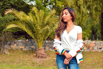 Young girl with crossed arms thinking looking to the side on nature background