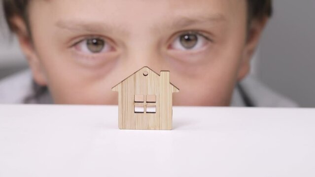 Wooden cut out house on the table. Closeup