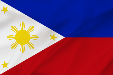 Philippines flag on waving silk background. Fabric texture.