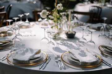 magical rustic wedding tables outside in the garden with hanging light and flowers, chairs, outdoor ceremony in the open air