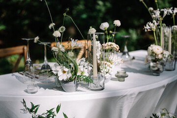 magical rustic wedding tables outside in the garden with hanging light and flowers, chairs, outdoor ceremony in the open air