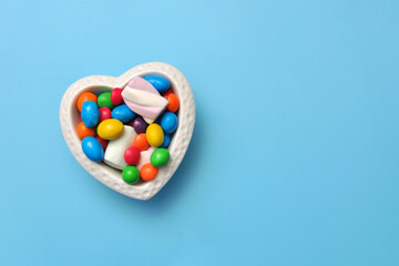 Sweets in a heart-shaped plate. Love of sweets