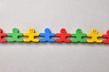 A group of wooden men. A symbol of teamwork or friendship between different people