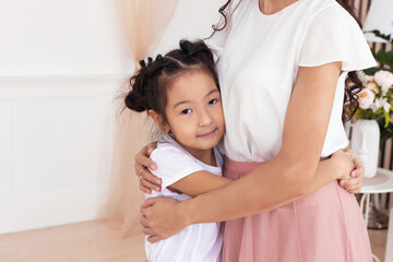 the girl hugs her mother. Place for text