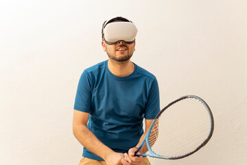Man playing tennis with his virtual reality goggles