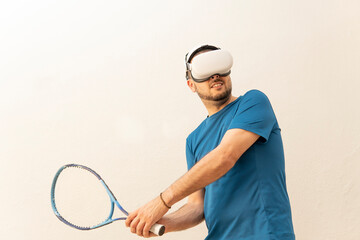 Man performing tennis move with his virtual reality goggles