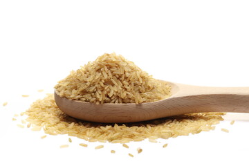 Integral uncooked rice pile in wooden spoon isolated on white  