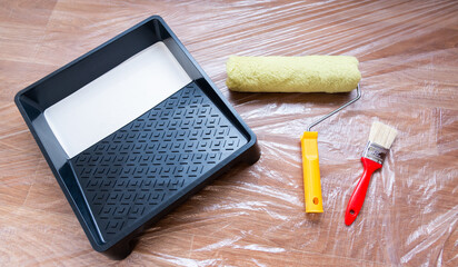 
tools for painting and apartment renovation. Brush, roller and white paint