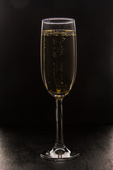 Champagne glass on black background