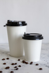 cardboard cups of coffee with beans. cardboard cups and coffee beans.