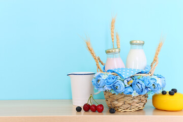 Photo of dairy products over wooden table. Symbols of jewish holiday - Shavuot