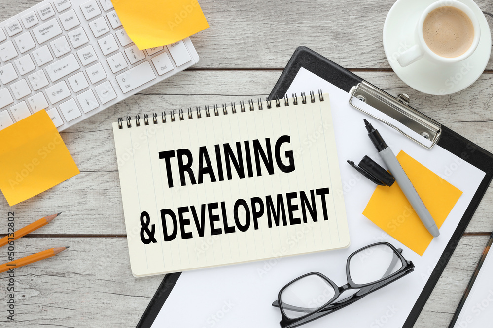 Poster training and development notepad on folder with clip text on page