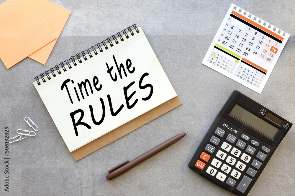 Poster time rules business concept. open notebook on a gray background near the calculator