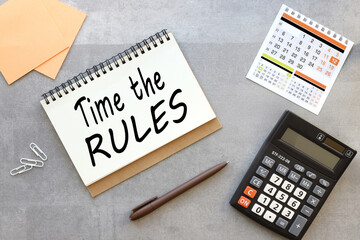 TIME RULES Business concept. open notebook on a gray background near the calculator