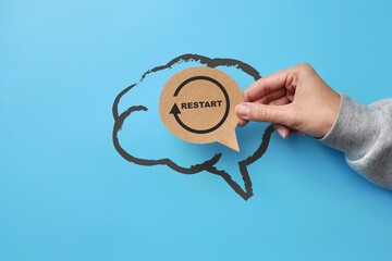 The silhouette of the brain and the inscription: restart in it. - obrazy, fototapety, plakaty