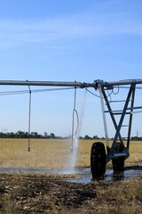 A shot of a broken Irrigation Equipment with a leak in a farm field south of Sterling Kansas USA with blue sky in a farm field.