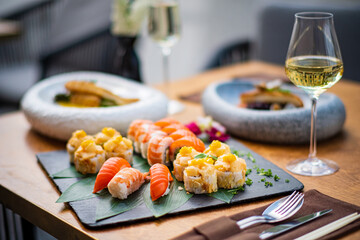 sushi and white wine outdoor © Maksim Shebeko