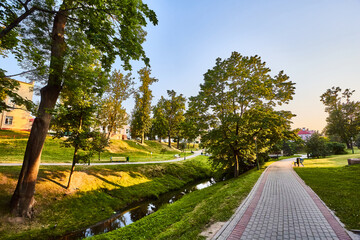 Fototapeta premium Urban landscape. A pleasant summer evening in the park. A place to rest after work