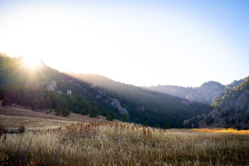 Beautiful sunset light over a field and distant mountains in the front range of Colorado