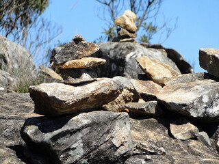 Landscape with stacked stones at daytime and blue sky
