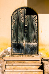 Old iron door in a shabby building.