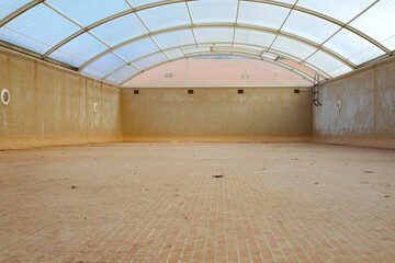 Indoor swimming pool empty, dirty and abandoned.