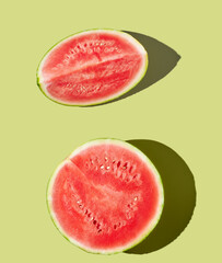 Cut watermelon on green pastel background