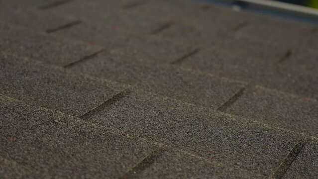Closeup view 4k stock video of special grey protective material on top of roof of residential building. Abstract gray background