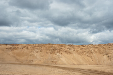 a sand quarry, in the photo a sand quarry and a gray sky in the background