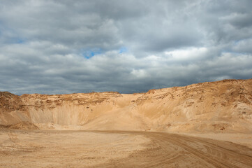 Fototapeta na wymiar a sand quarry, in the photo a sand quarry and a gray sky in the background
