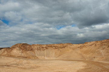 a sand quarry, in the photo a sand quarry and a gray sky in the background