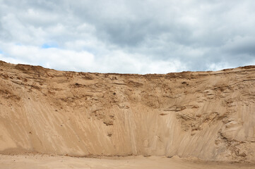 a sand quarry, in the photo a sand quarry and a gray sky in the background