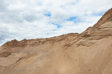 Fototapeta na wymiar a sand quarry, in the photo a sand quarry and a gray sky in the background