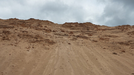 a sand quarry, in the photo a sand quarry and a gray sky in the background