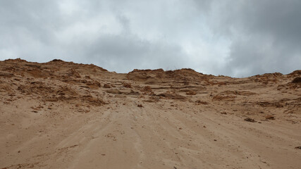 a sand quarry, in the photo a sand quarry and a gray sky in the background