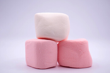 pink marshmallows stacked on a white background